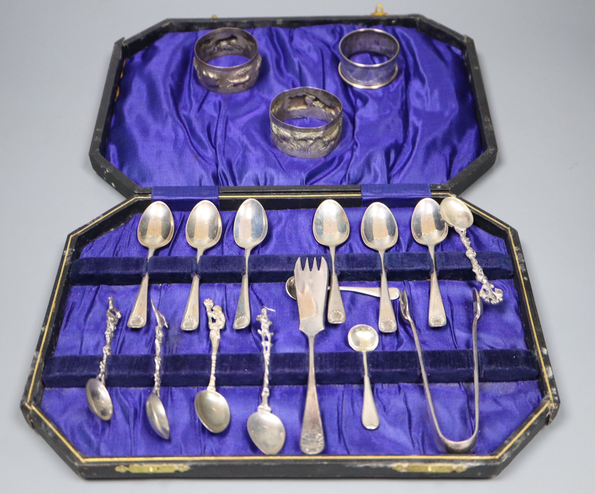 A set of six George V silver Old English and shell pattern teaspoons, other minor cutlery and three white metal napkin rings.